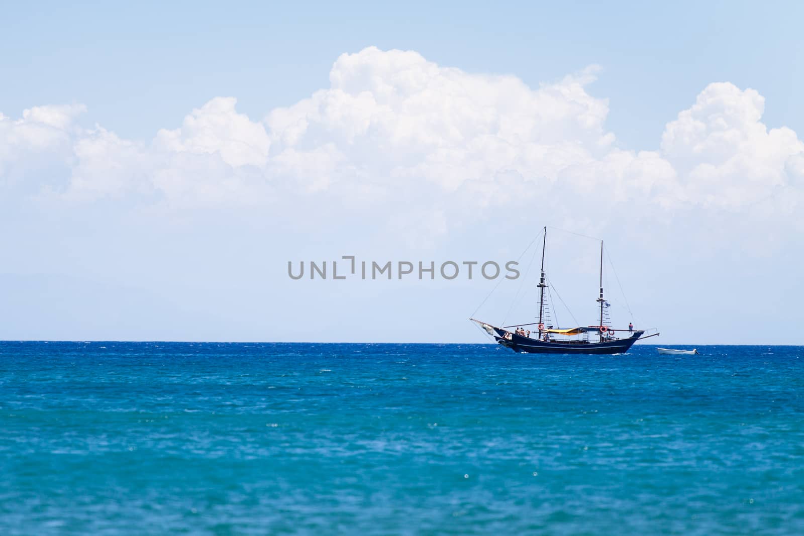 Lonely ship boat sailing near Rhode Island in Greece. Beautiful seascape background.