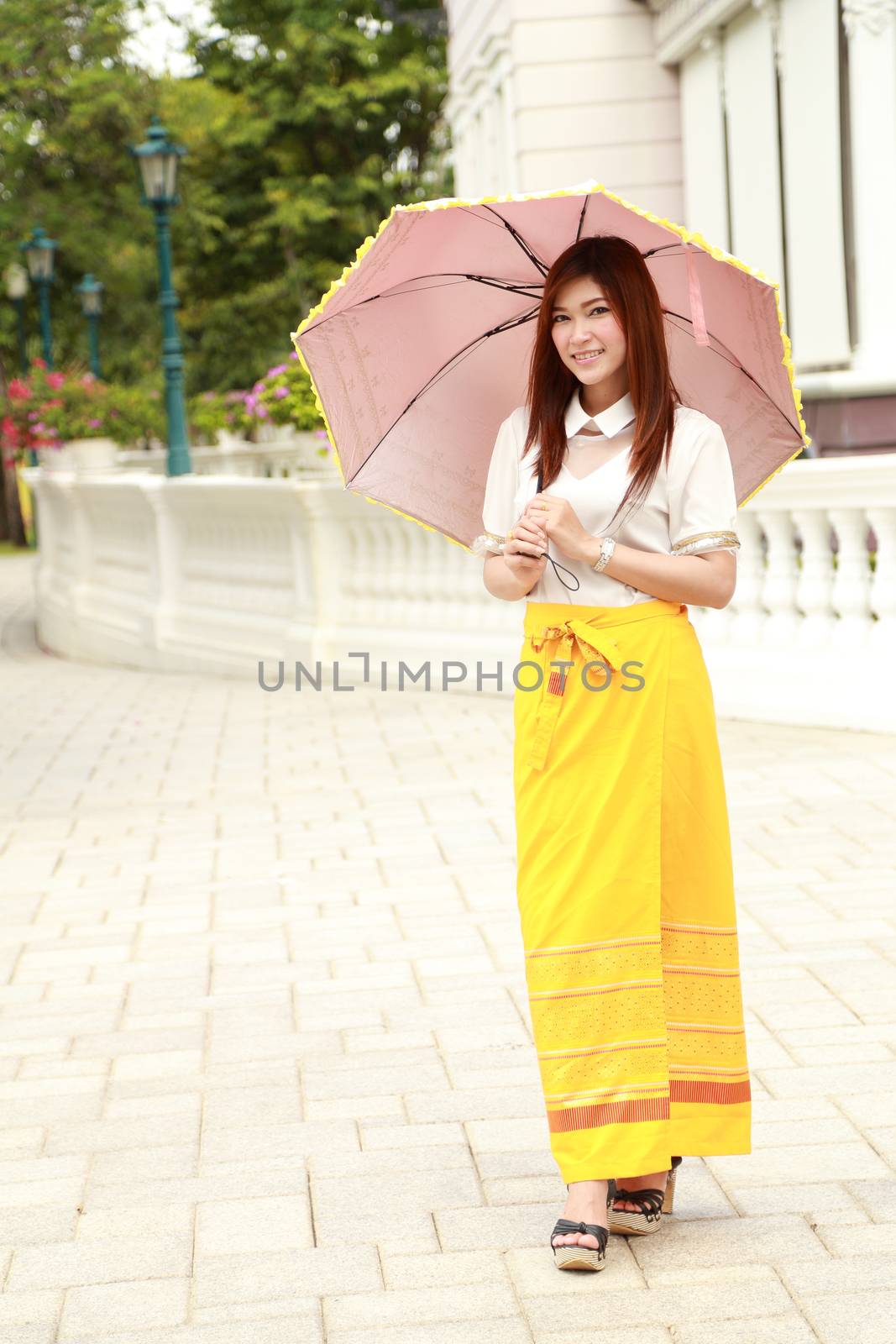 Thai girl dressing and umbrella with traditional style by geargodz