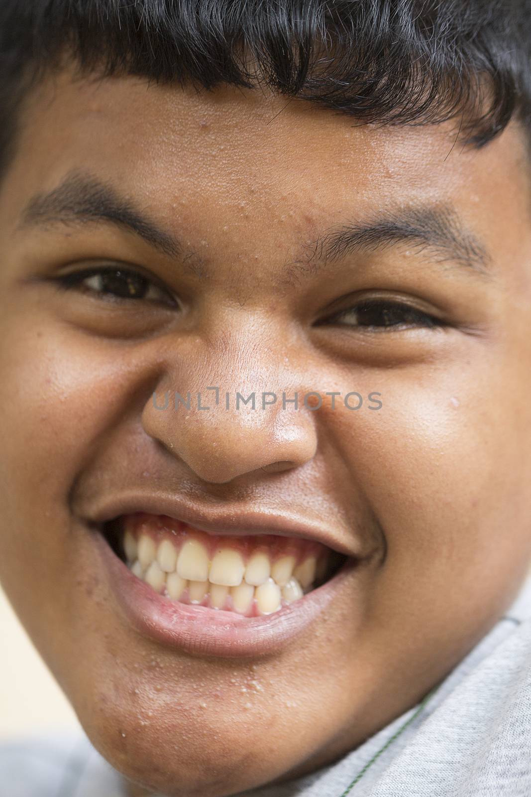Close up portrait of a happy Thai teen boy