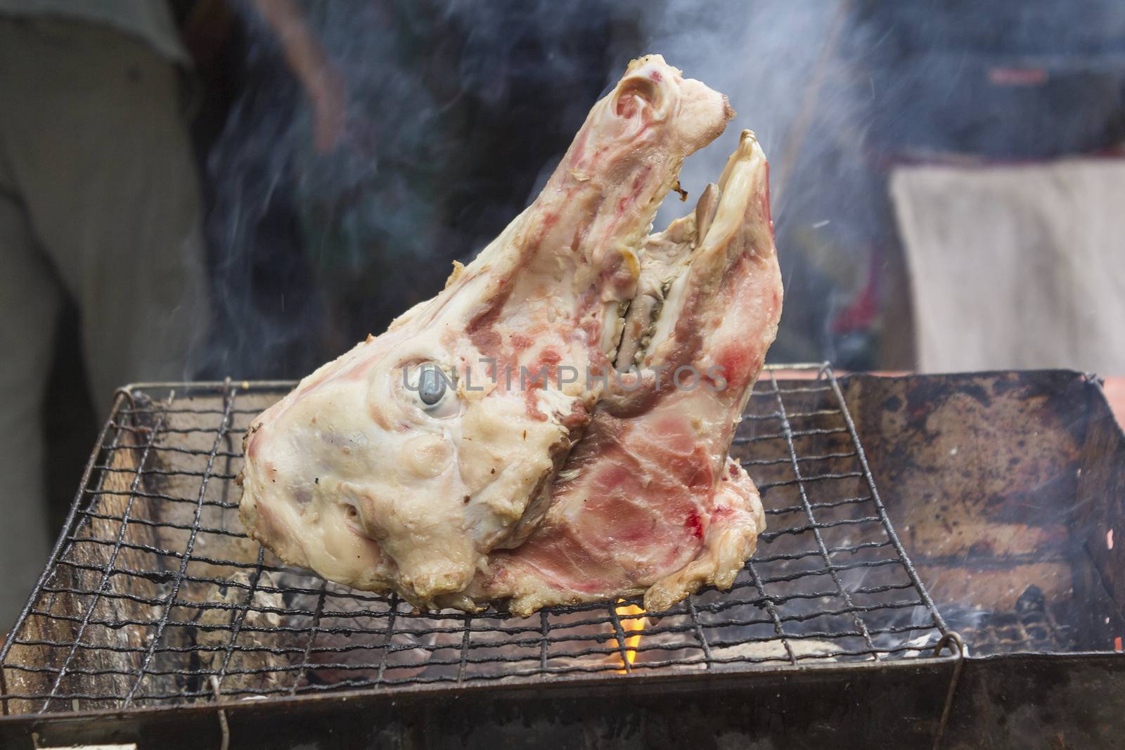 Roast pig's head on grill
