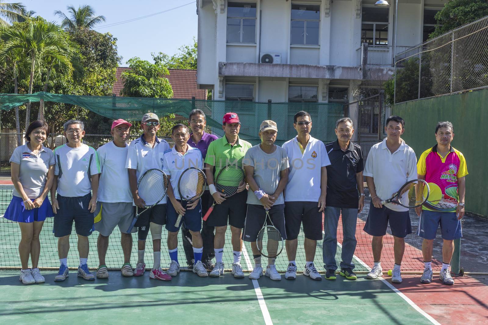 SURAT THANI, THAILAND - MARCH 1: Group of Thai tennis players holding rackets at Chaiya tennis court on March 1, 2014 in Surat Thani, Thailand.