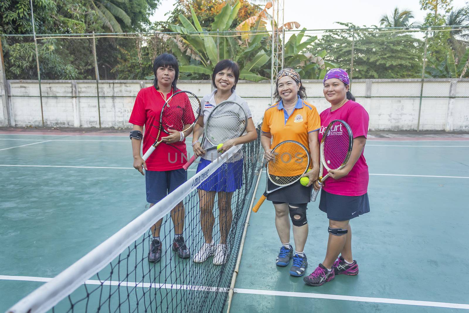 SURAT THANI, THAILAND - MARCH 1: Group of Thai tennis players holding rackets at Chaiya tennis court on March 1, 2014 in Surat Thani, Thailand.