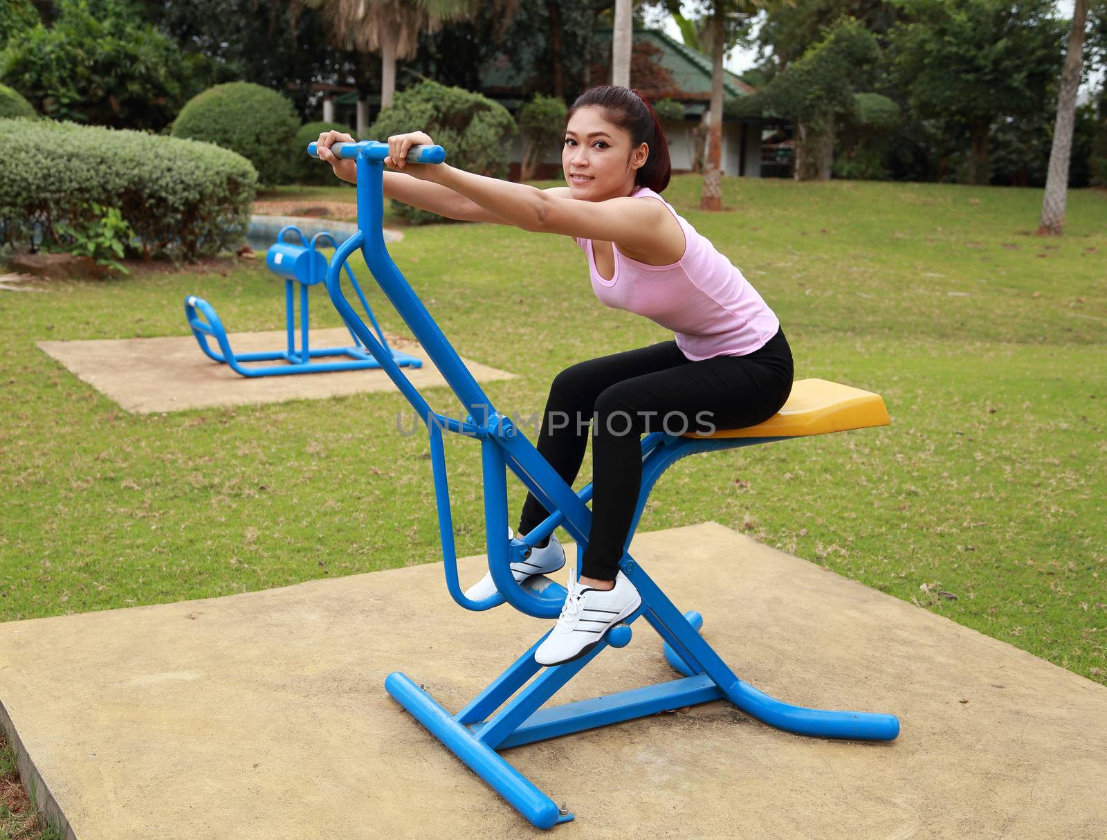 woman exercising with exercise equipment in the public park