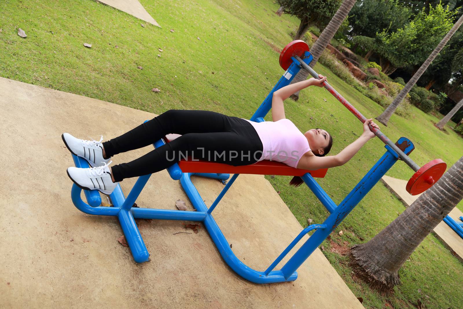 woman exercising with exercise equipment in the public park