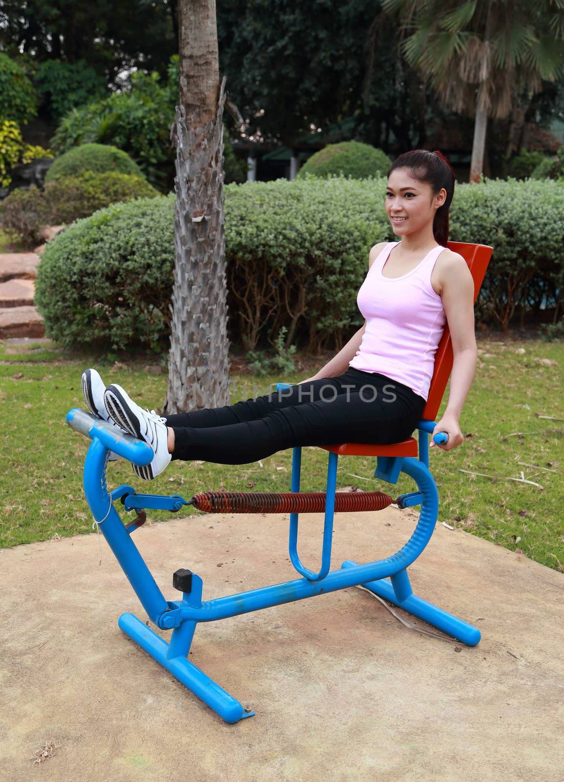 woman exercising with exercise equipment in the park by geargodz