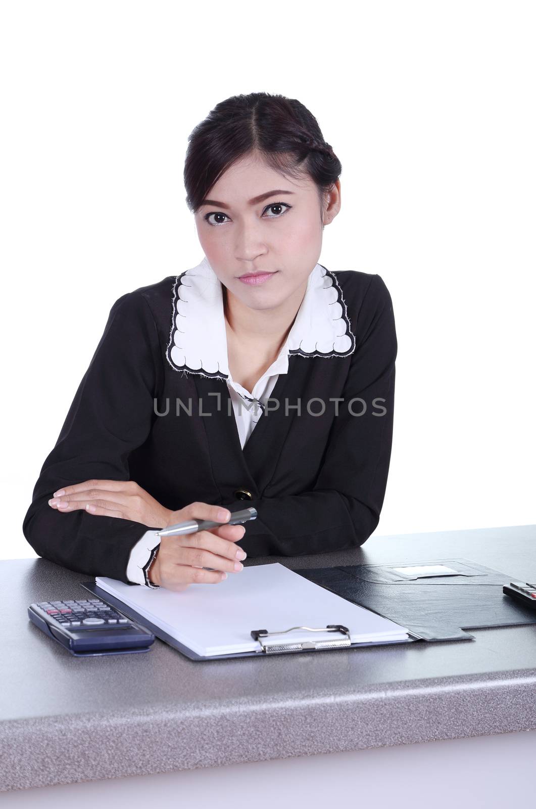business woman sitting on her desk holding a pen working with do by geargodz