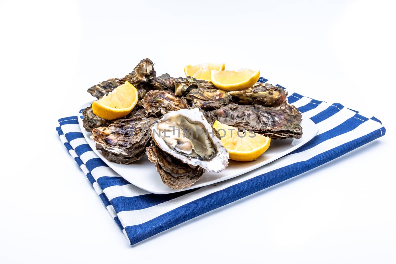 Lots of oysters on a dish with lemon