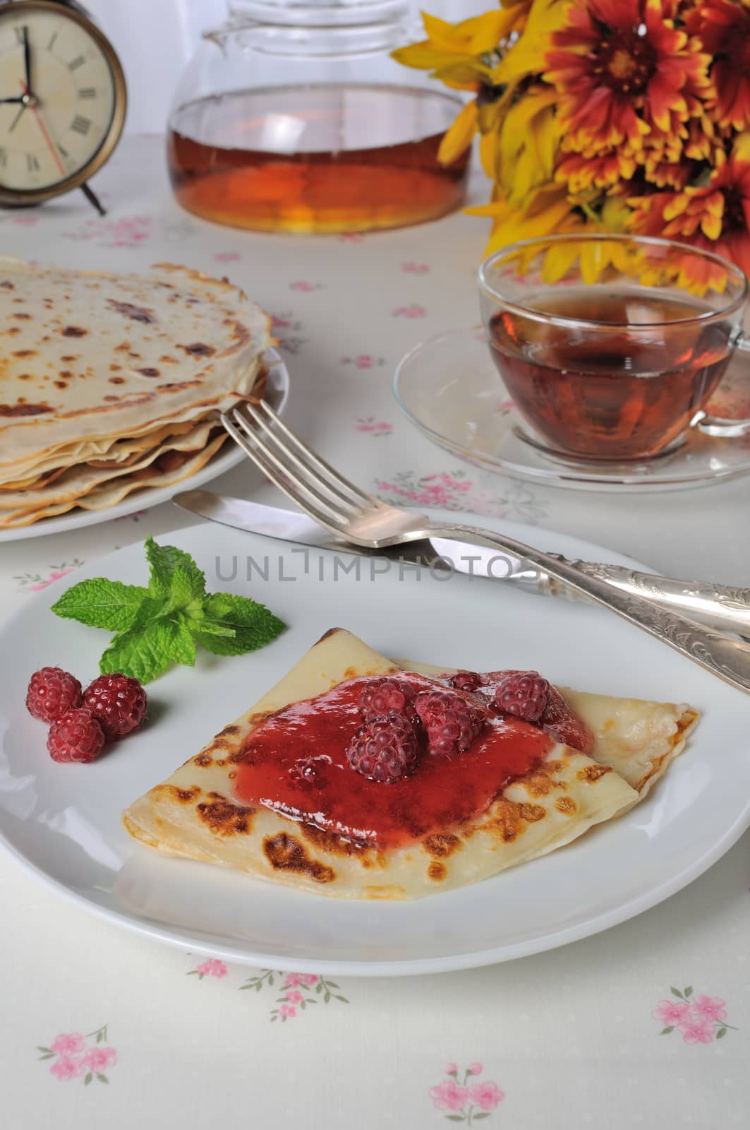 Pancakes with raspberry jam and berries