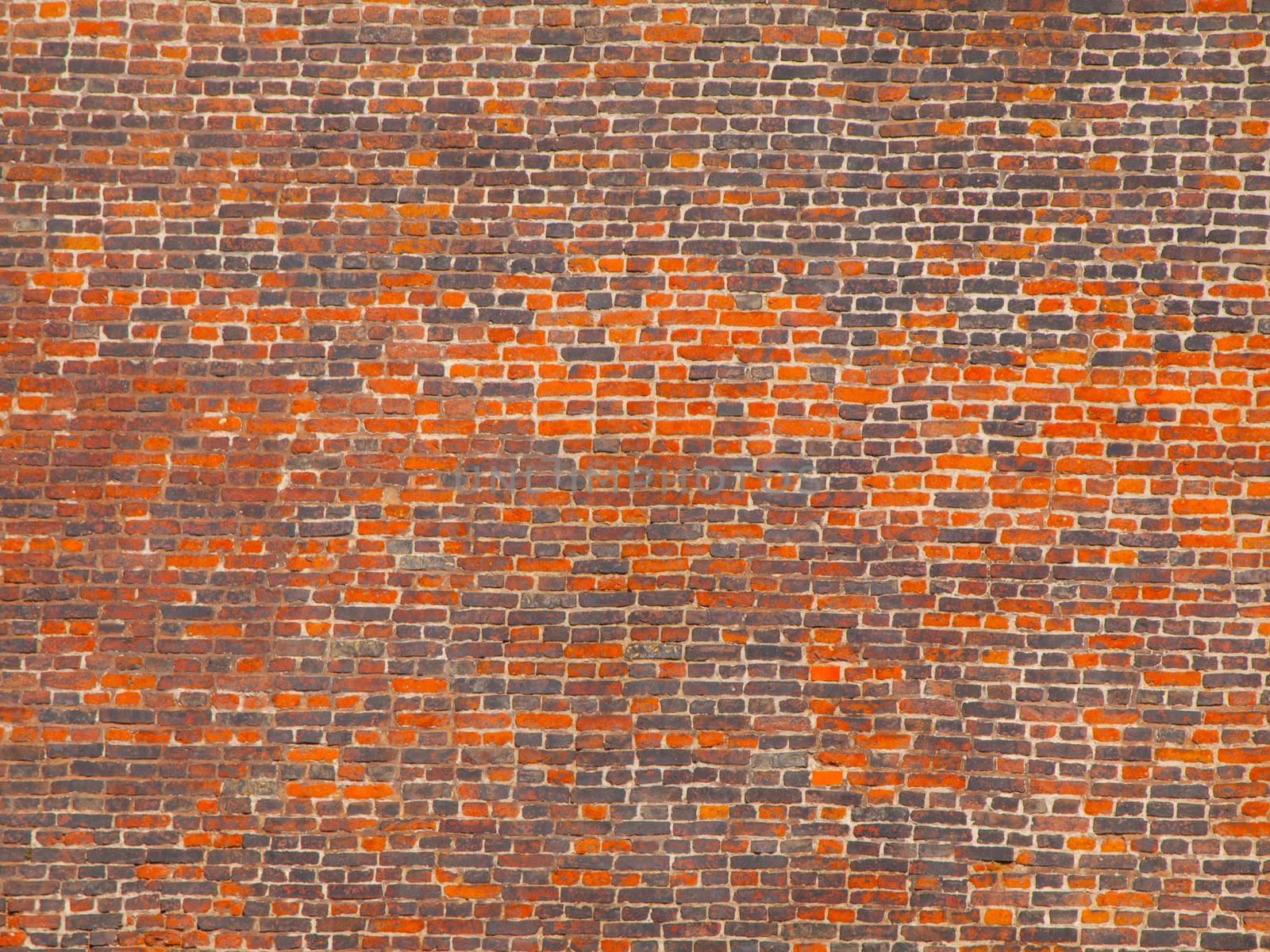 Big wall made of orange and grey bricks