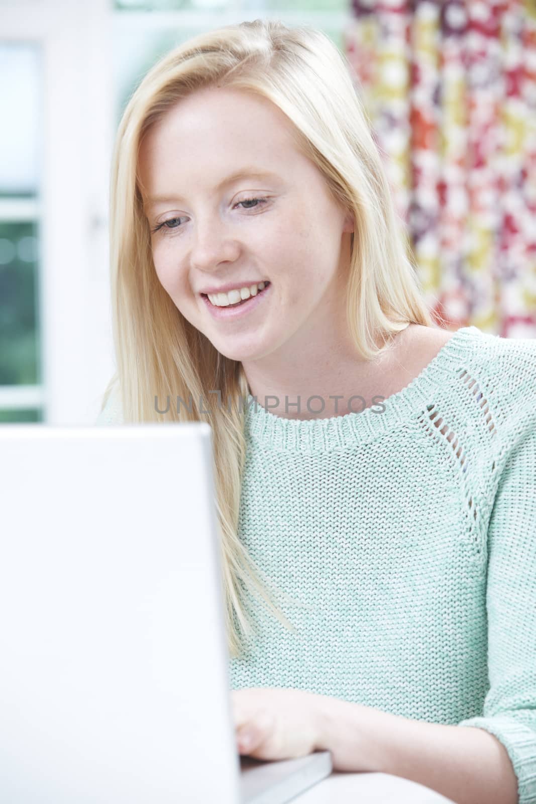 Teenage Girl Using Computer At Home