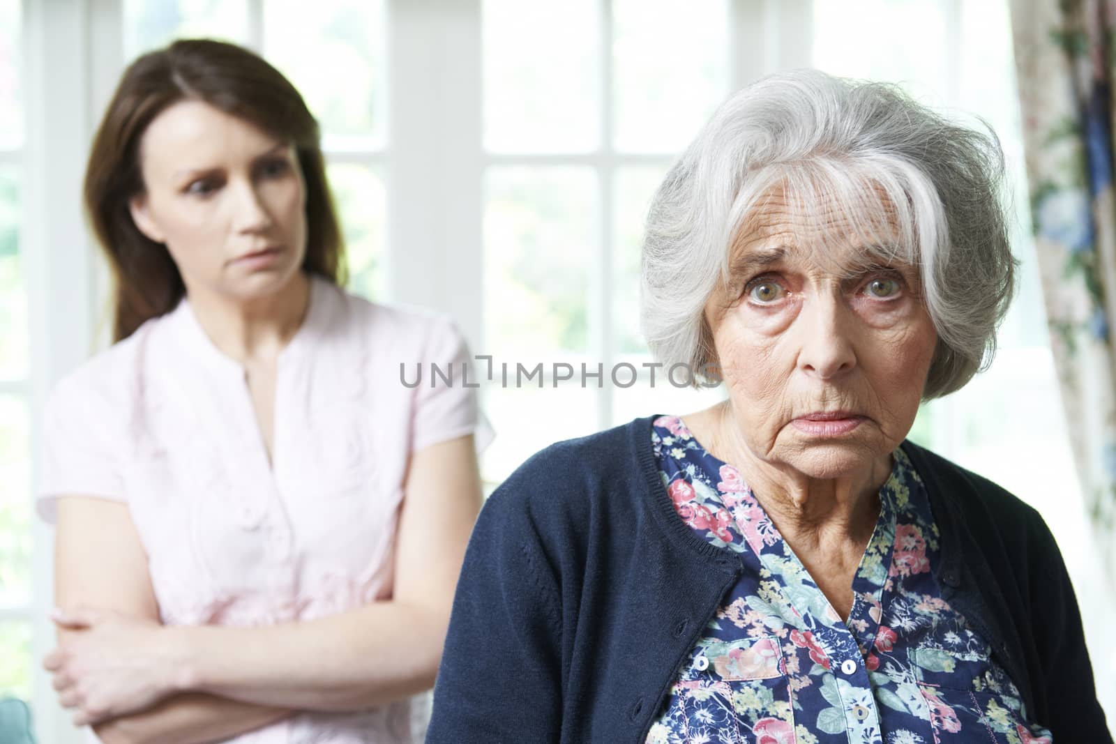 Serious Senior Woman With Worried Adult Daughter At Home