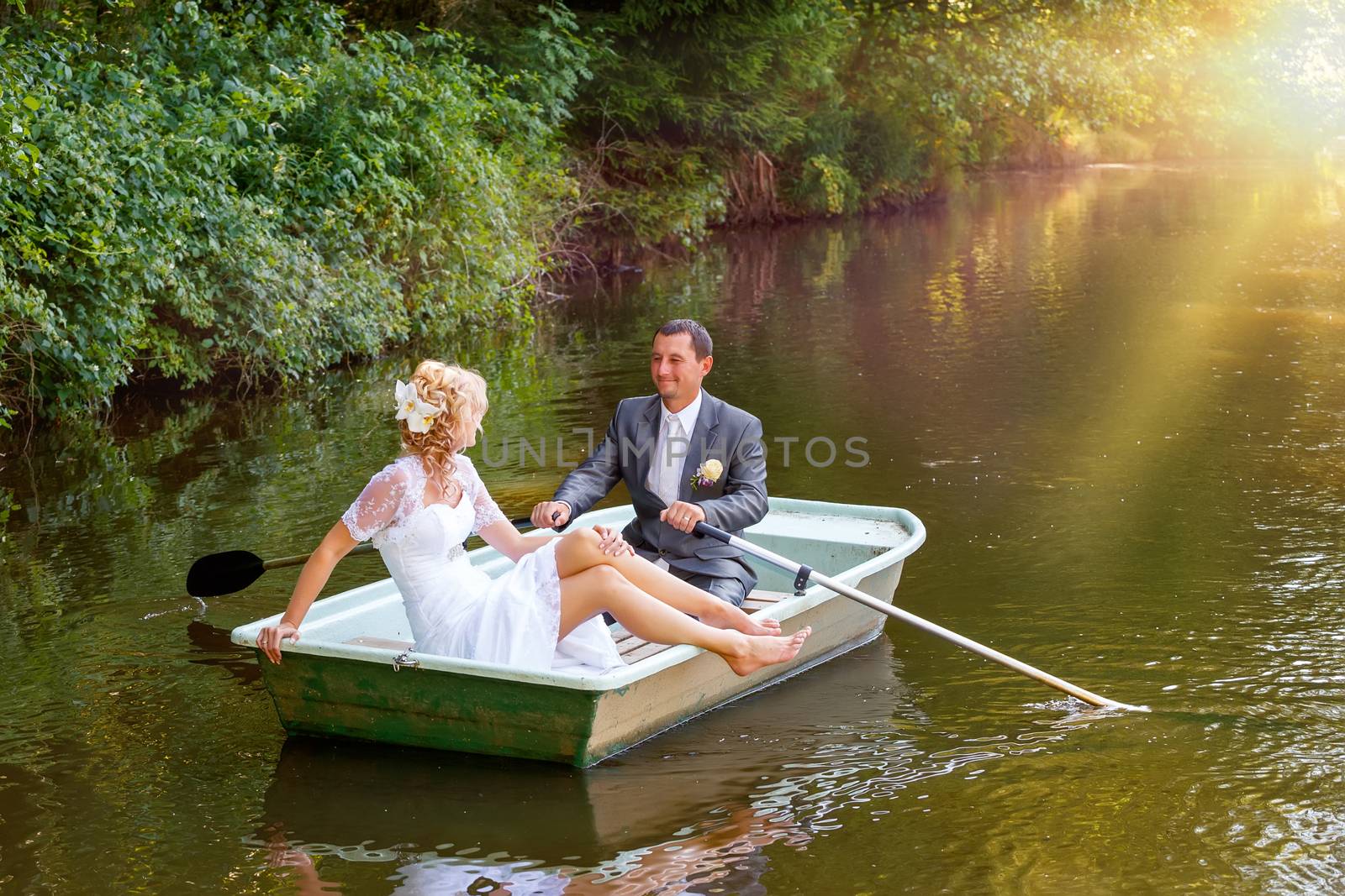 Young just married bride and groom on boat by artush