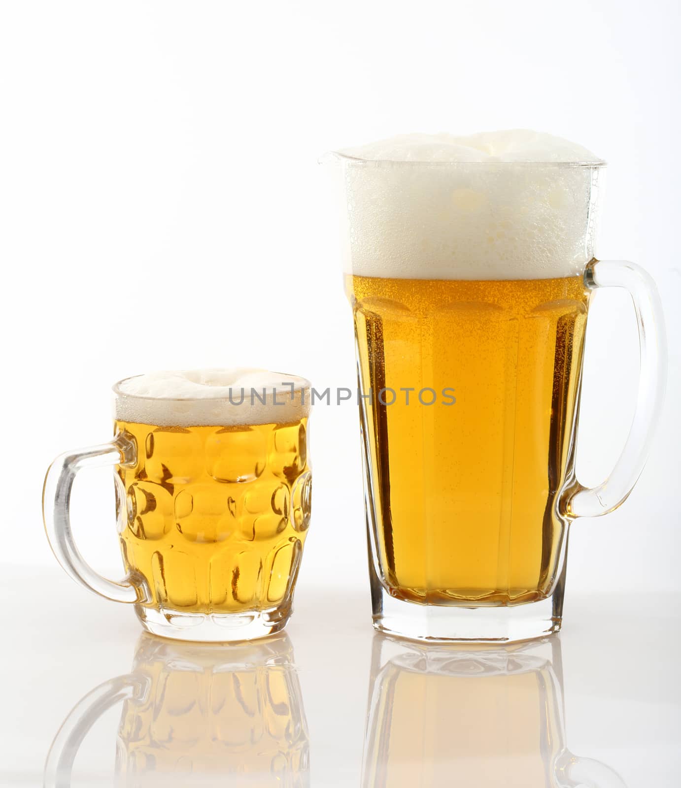 jug of beer and mug over white