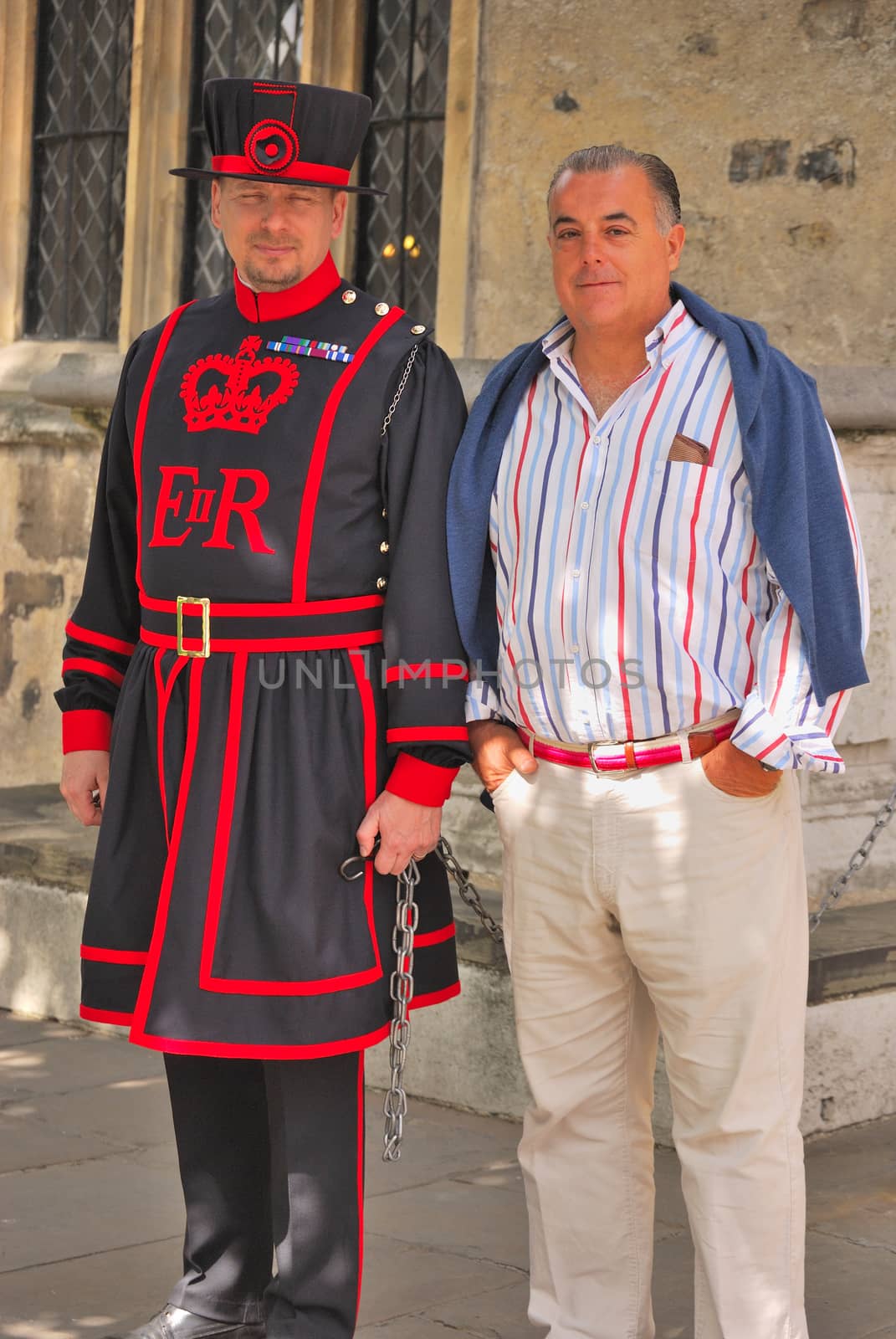 Beefeater, guard at the Tower of London, with a tourist