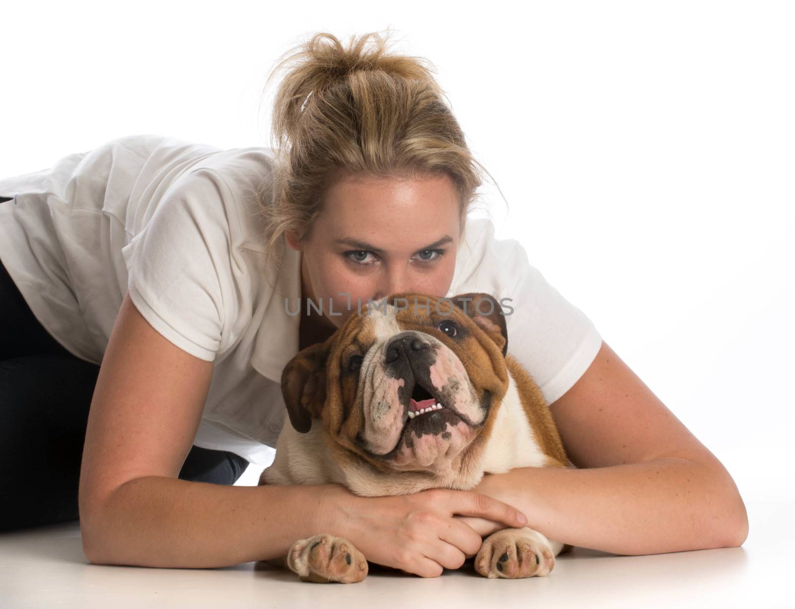 woman hugging english bulldog puppy