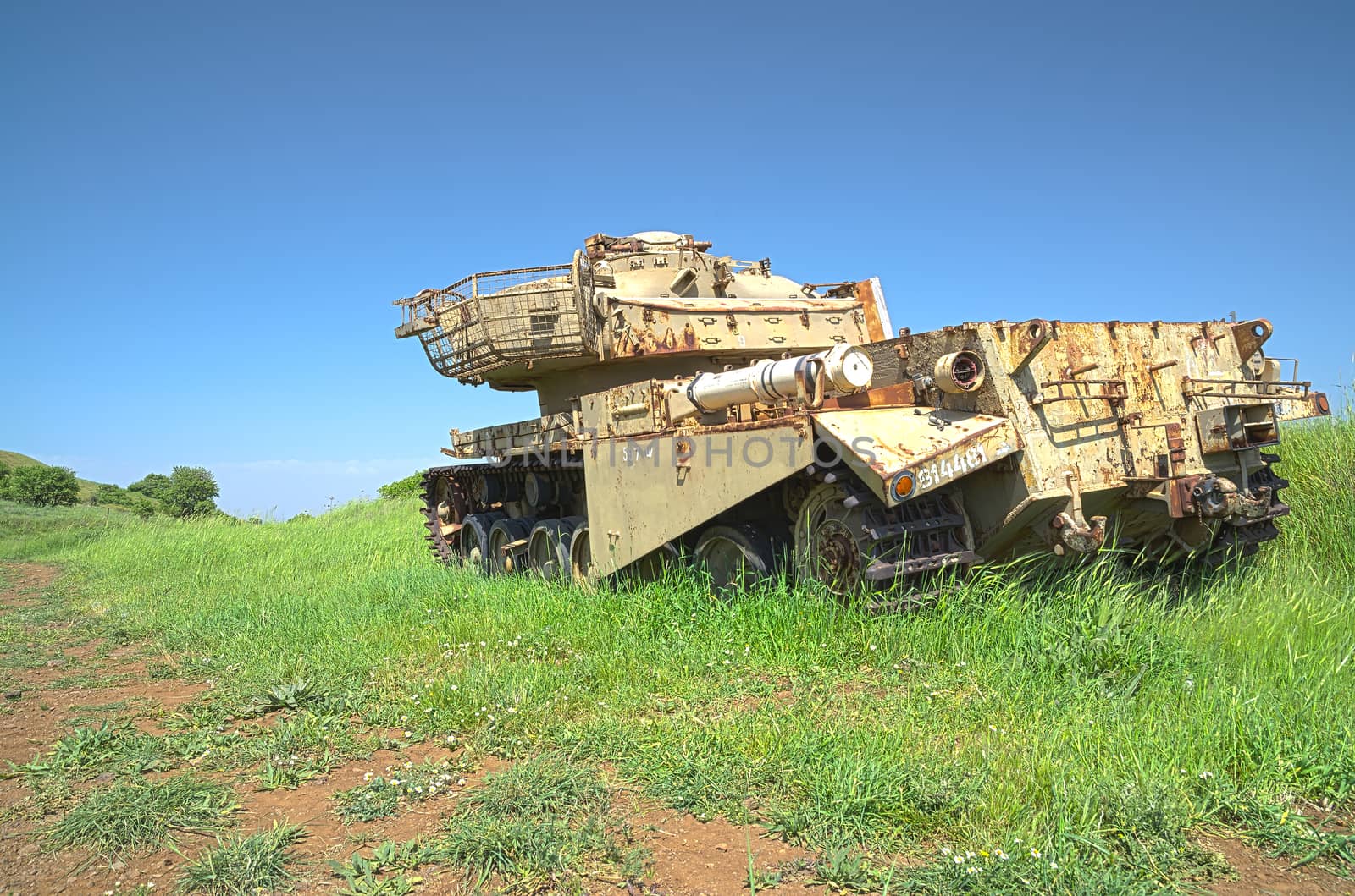 HDR photo of destroyed rusty tank on battlefield emplacement