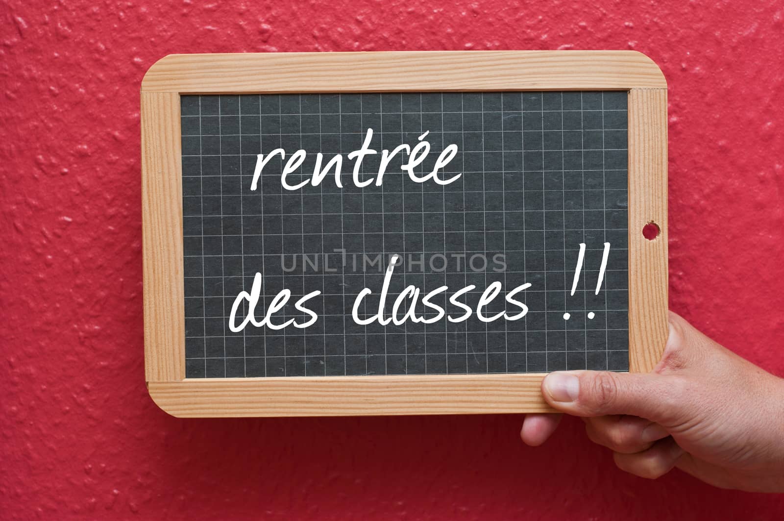 Chalkboard in hand - back to school -text in french
