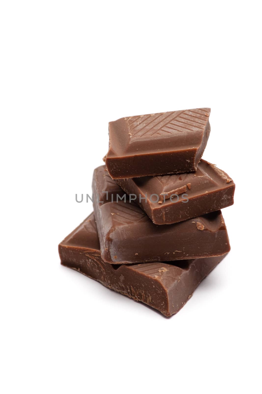 stack of dark chocolate pieces on white background