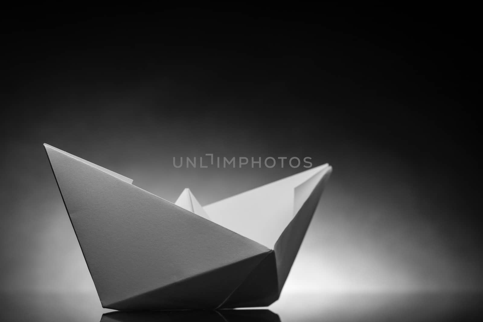 white origami paper boat with white back light