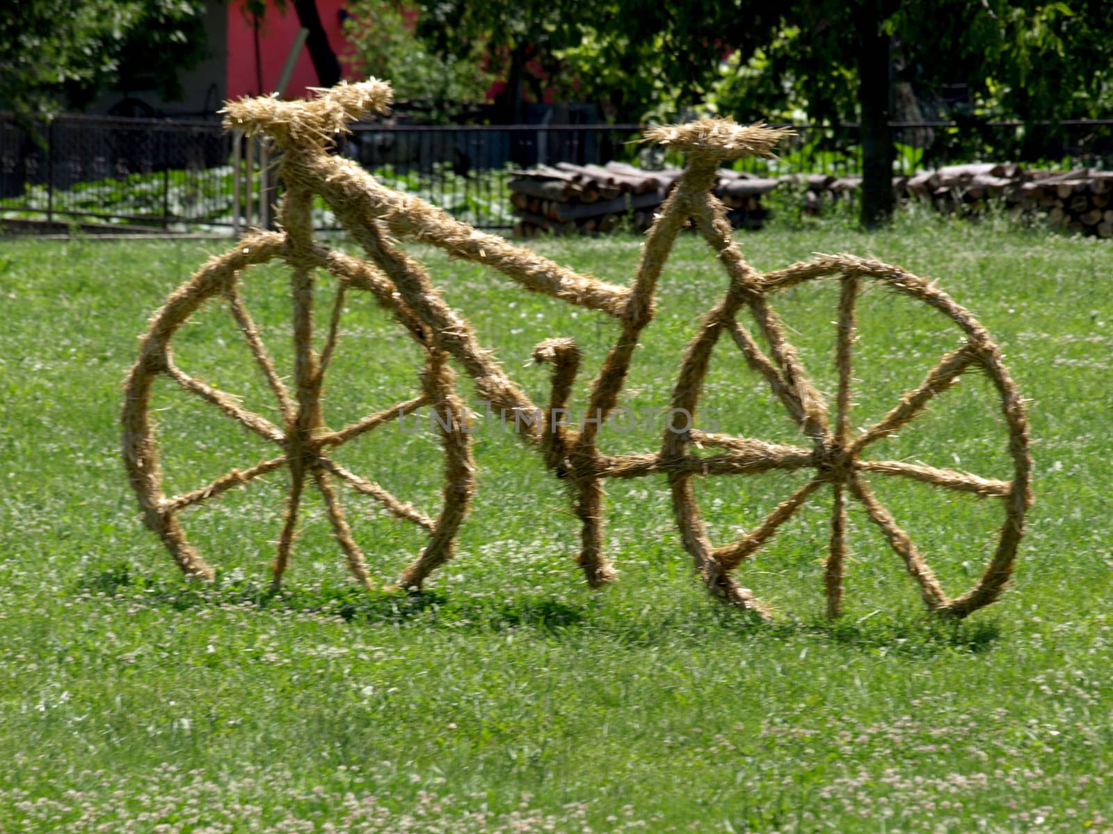 bike sculpture of straw on the lawn