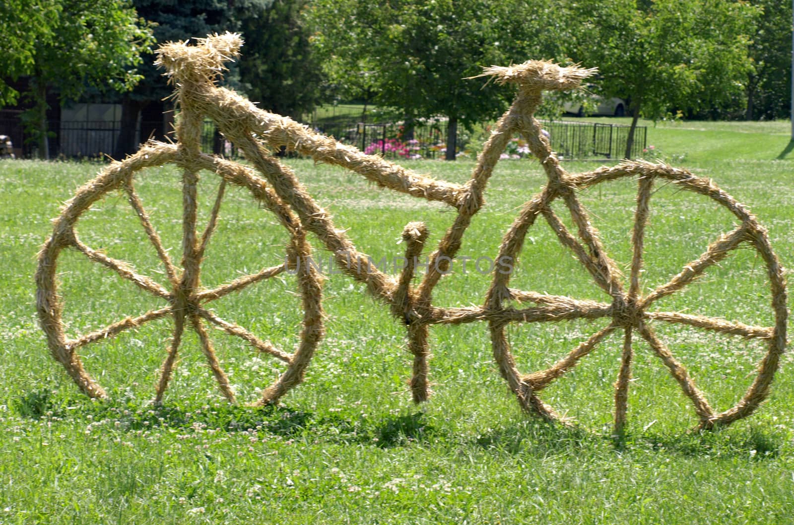 bike sculpture of straw on the lawn    
