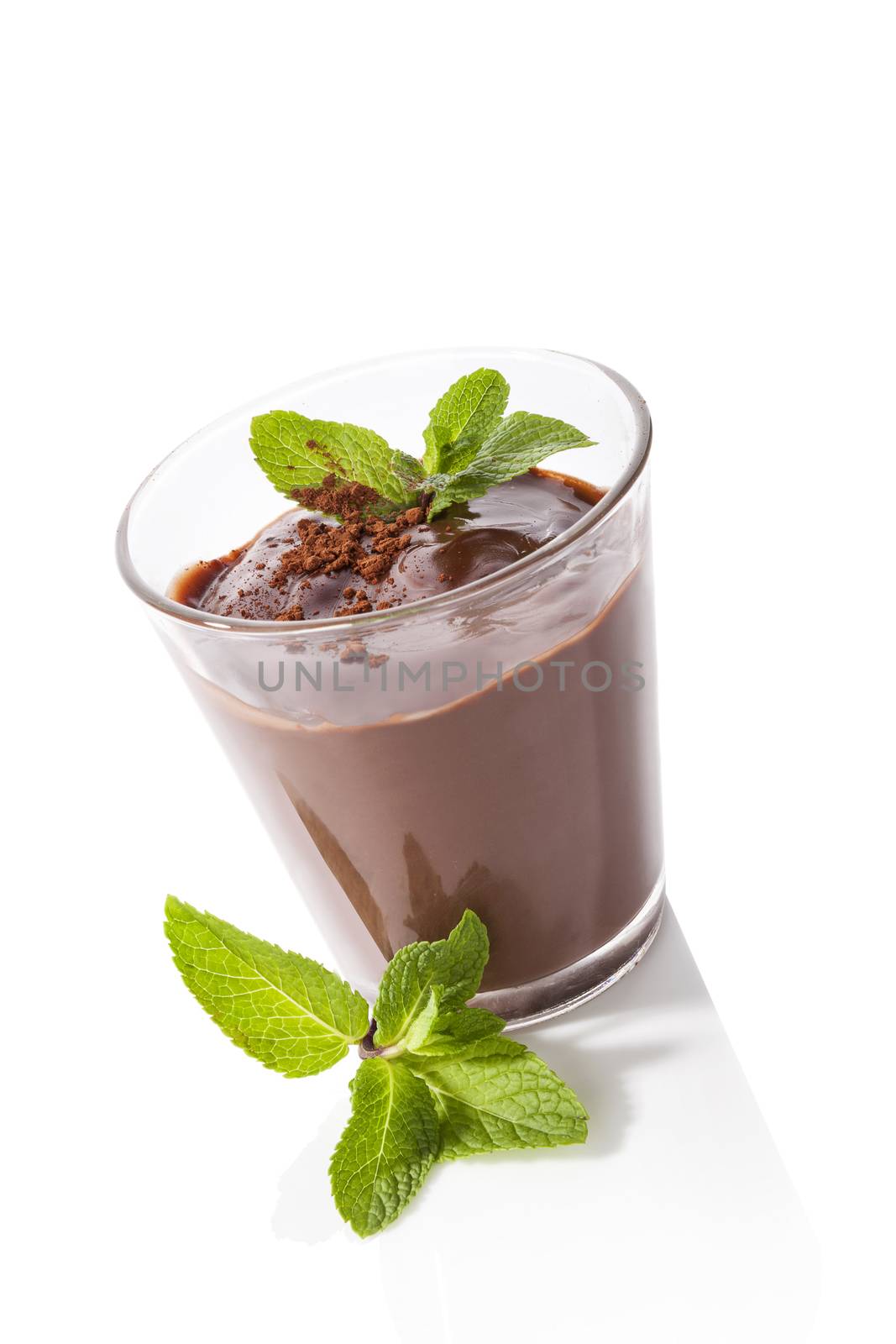 Chocolate pudding with fresh mint isolated on white background. Sweet dessert eating. 