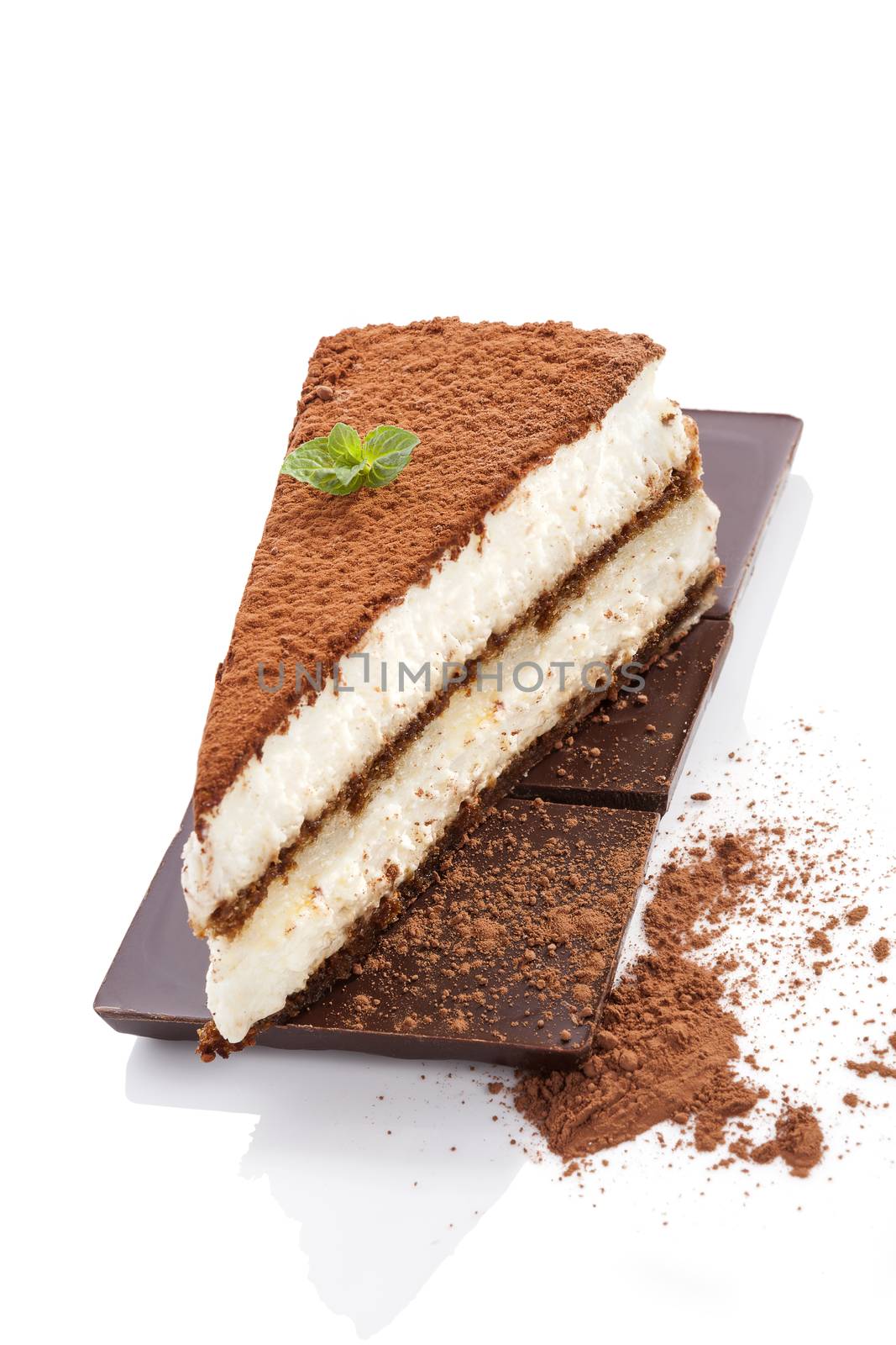 Delicious tiramisu dessert on chocolate bar with cocoa powder isolated on white background. Traditional sweet dessert.