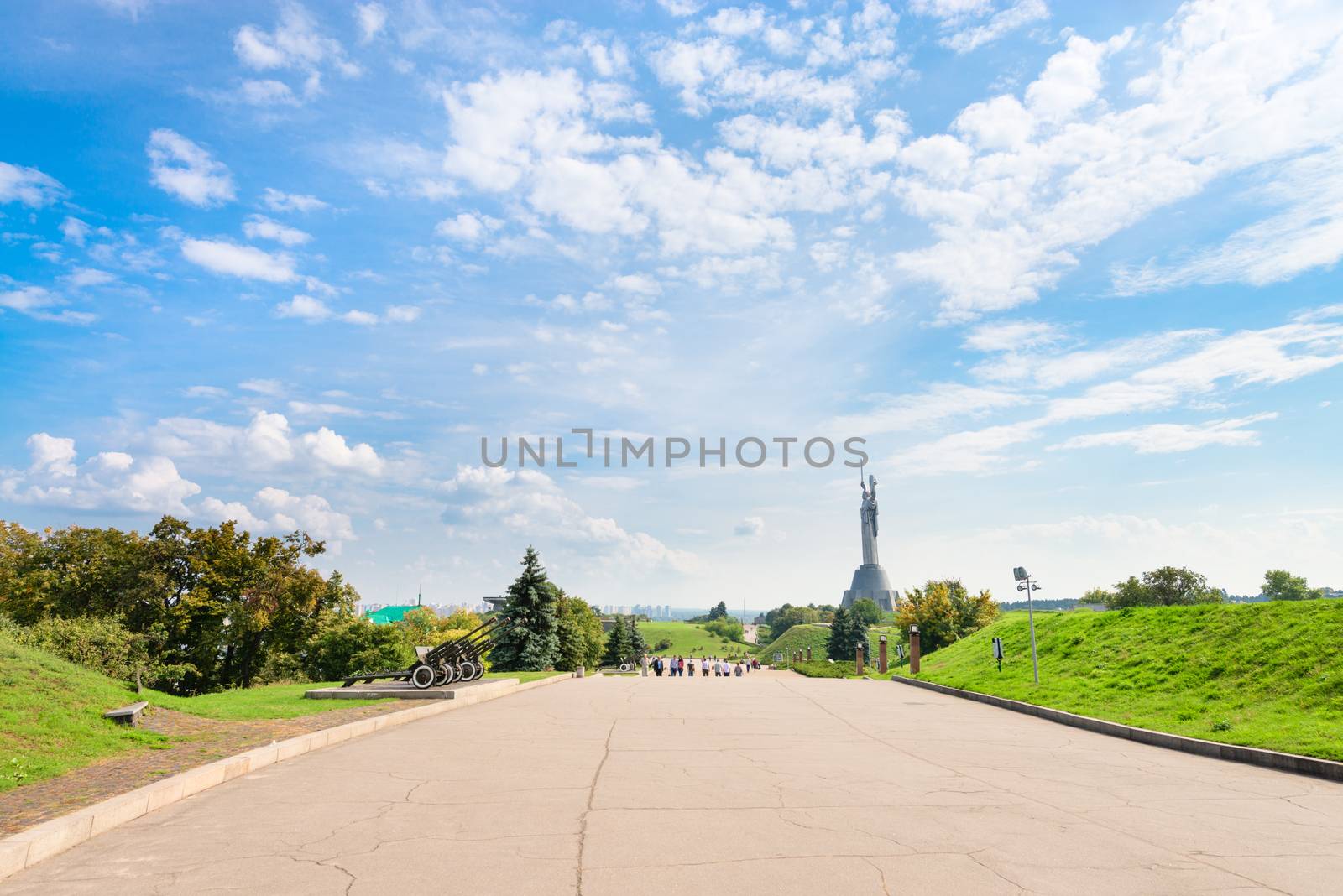 Wide pedestrian walking road in the Ukrainian State Museum of the Great Patriotic War with Monumental statue Mother Motherland on background.