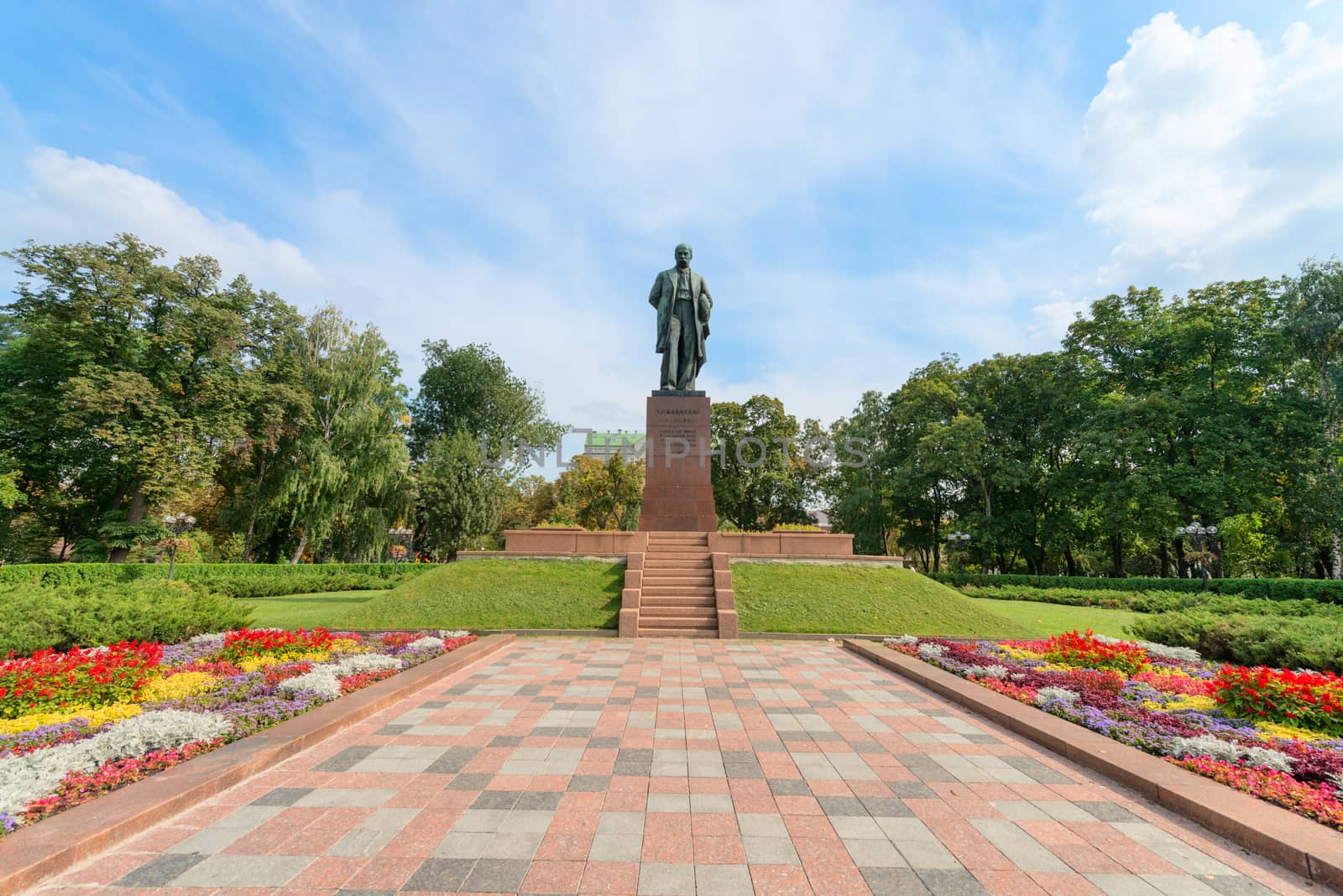 Taras Shevchenko monument in Shevchenko park, Kyiv, Ukraine under blue sky