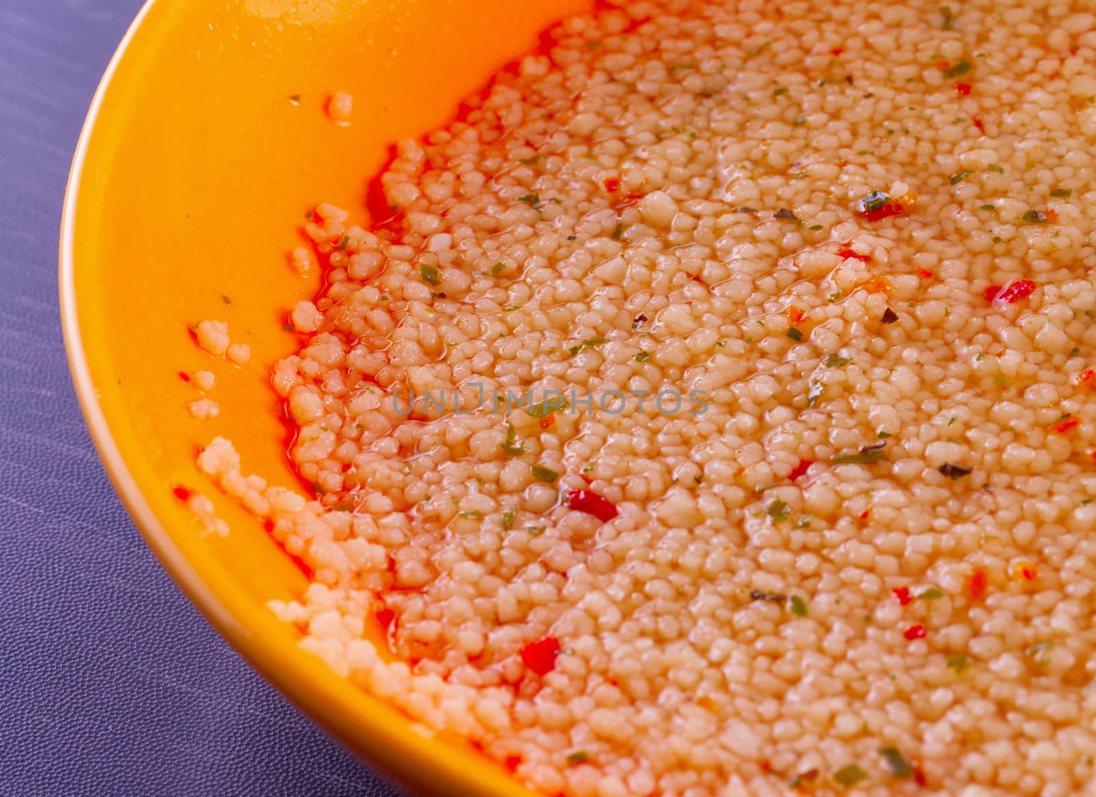 Cous cous in close up in a yellow plate