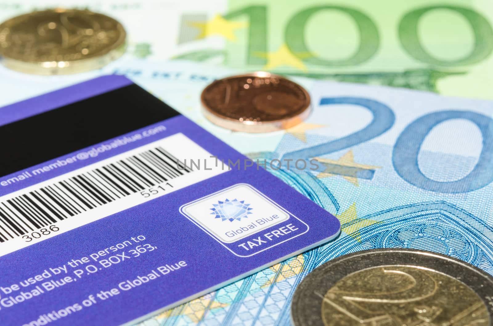 MUNICH, GERMANY - FEBRUARY 24, 2014: Closeup logotype Global Blue on the backside of plastic card against Euro cash