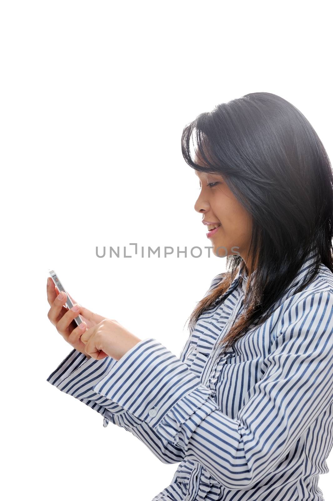 Happy asian girl texting on a smartphone