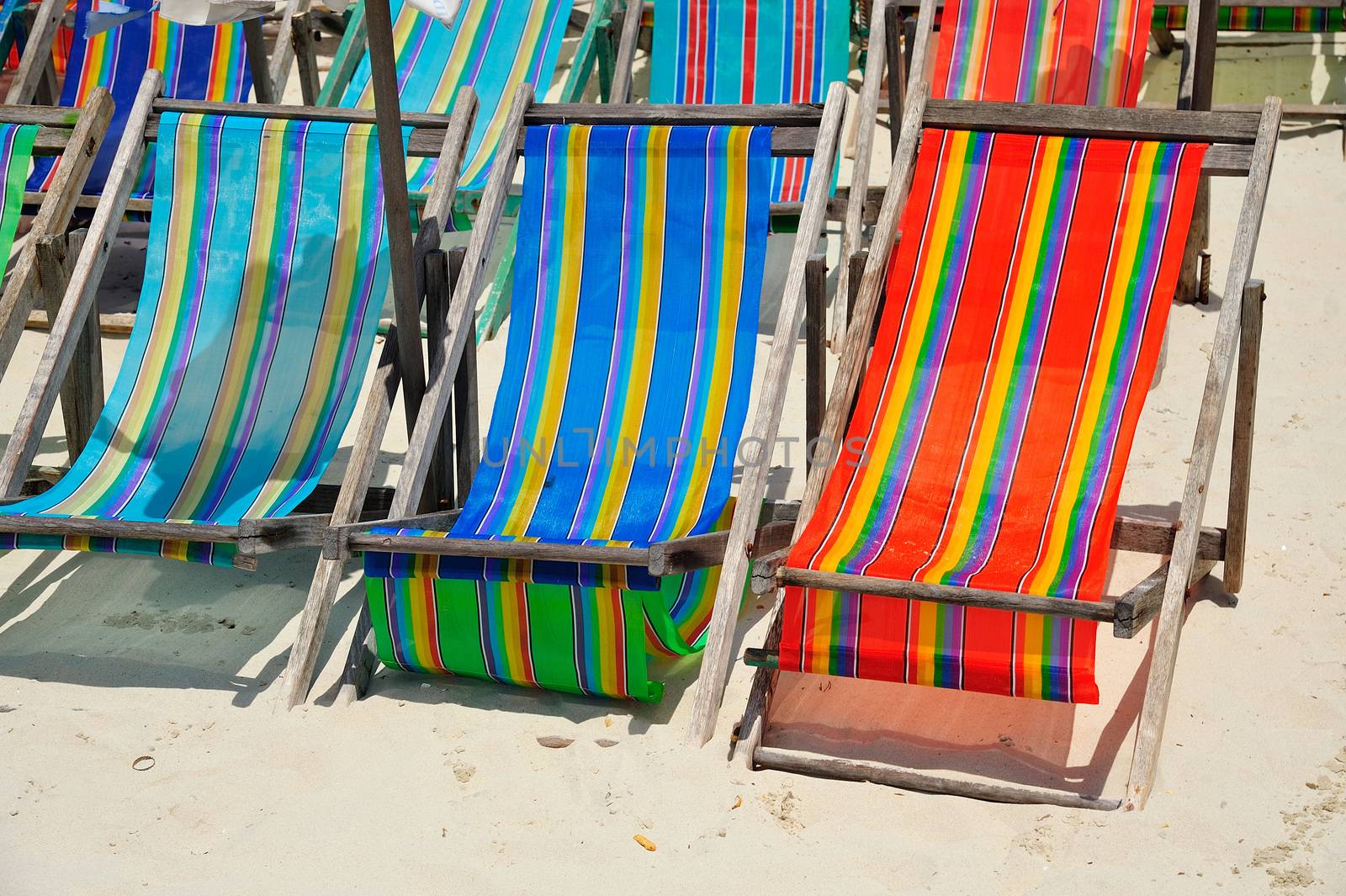 colorful of Deck Chairs on the Beach in Sunny Day ,Pattaya Thail by think4photop