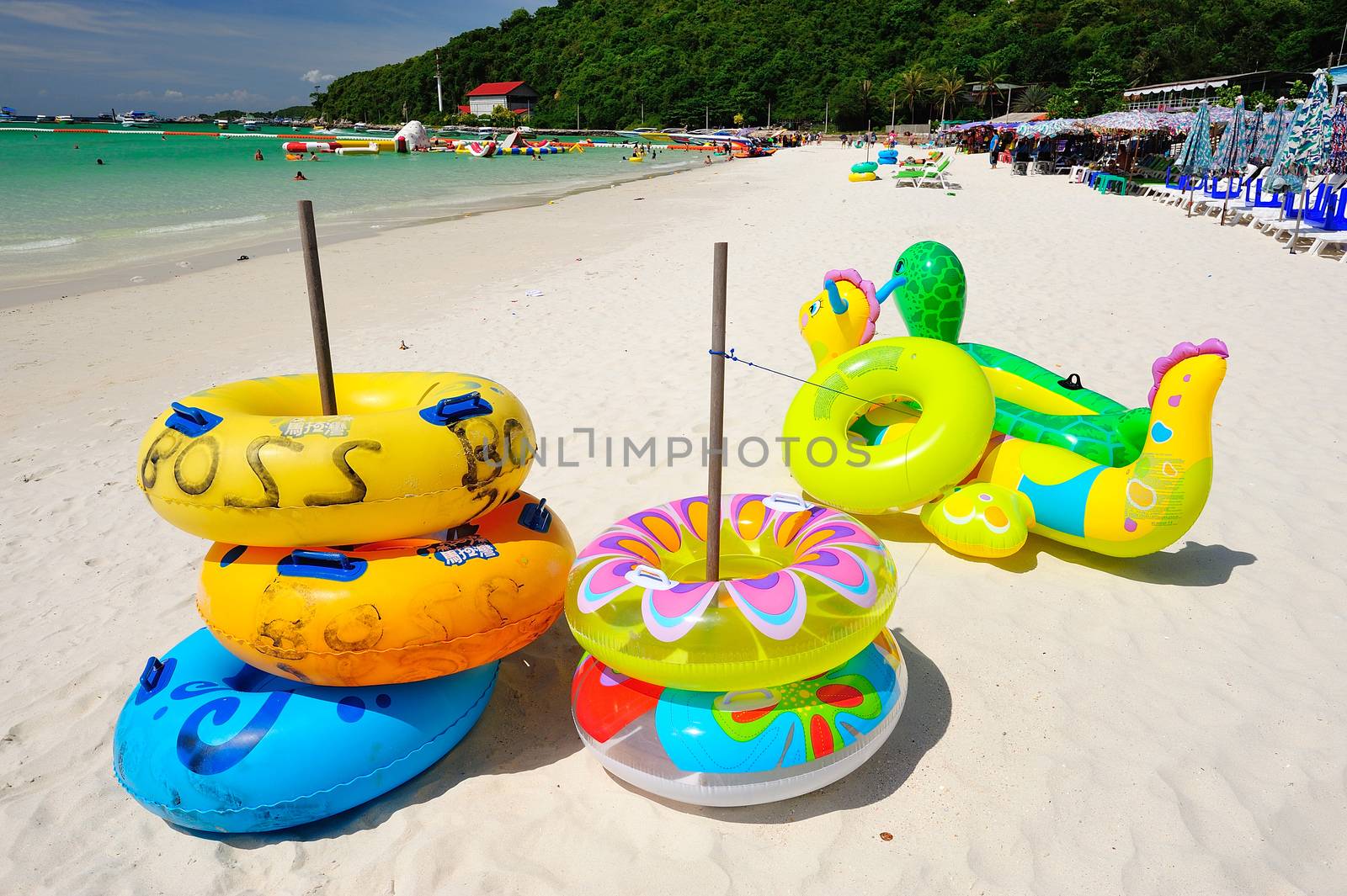 colorful life buoy on the beach at koh lan pattaya, thailand by think4photop