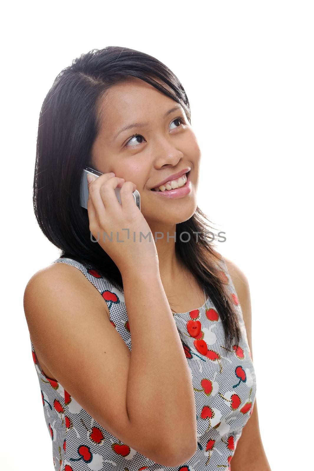 Asian girl looking happy and talking on mobile phone