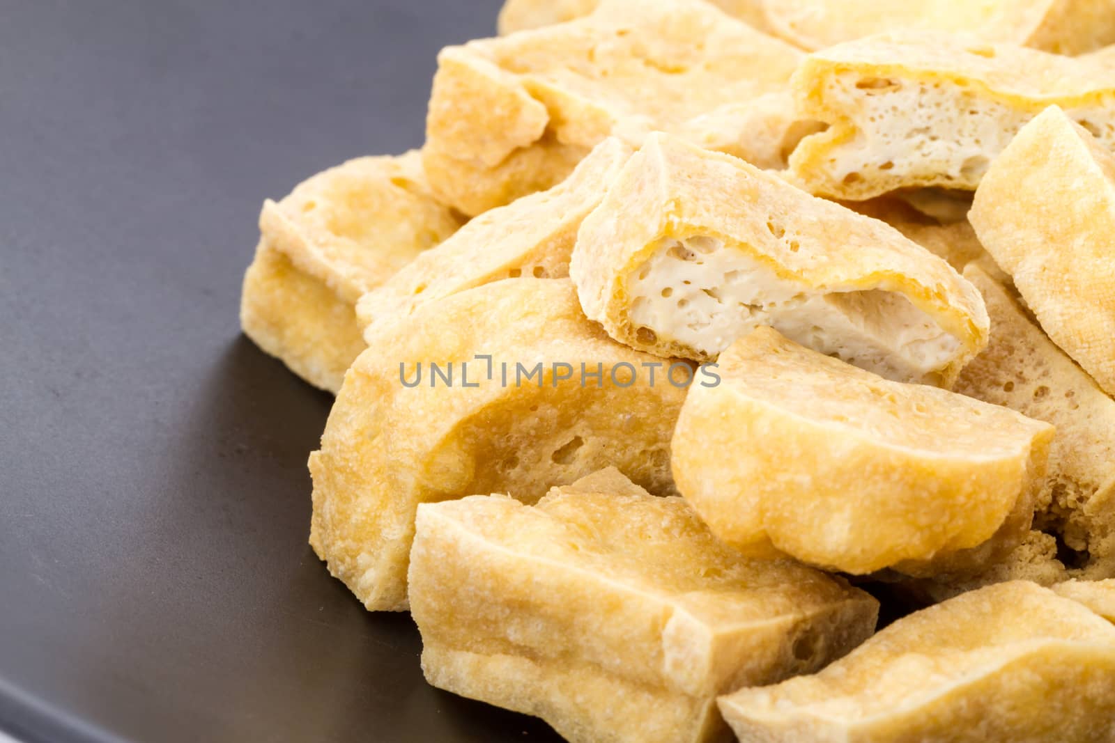 deep fried tofu on black dish