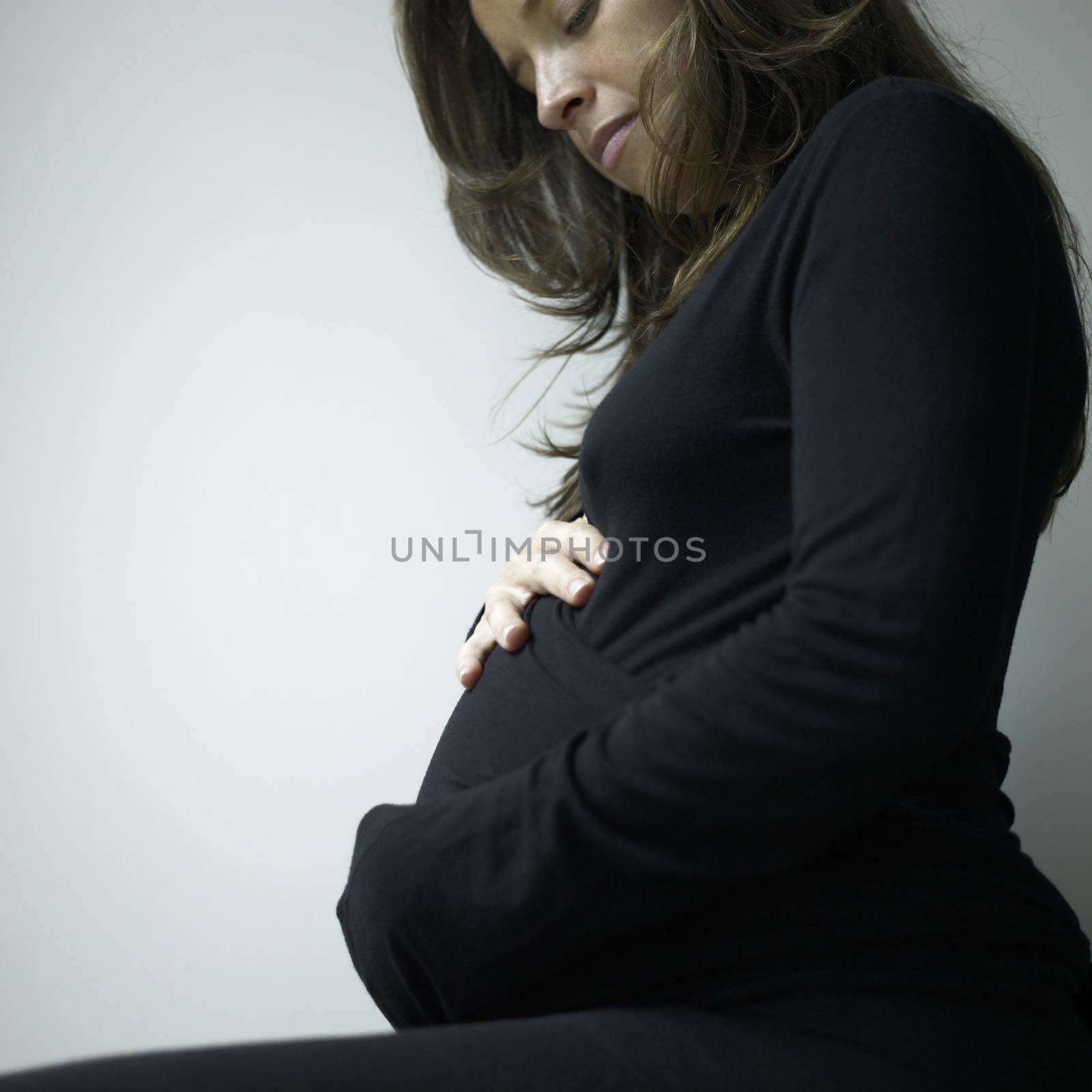 Closeup of a pregnant woman wearing black
