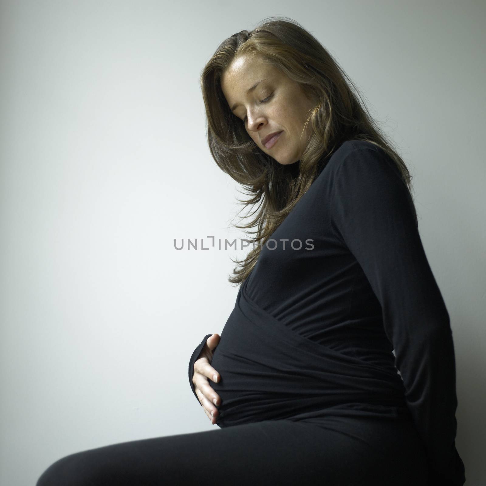 Closeup of a pregnant woman wearing black