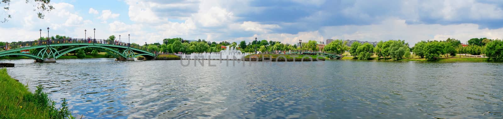 Summer Panorama: bridge over the river and fountain                               
