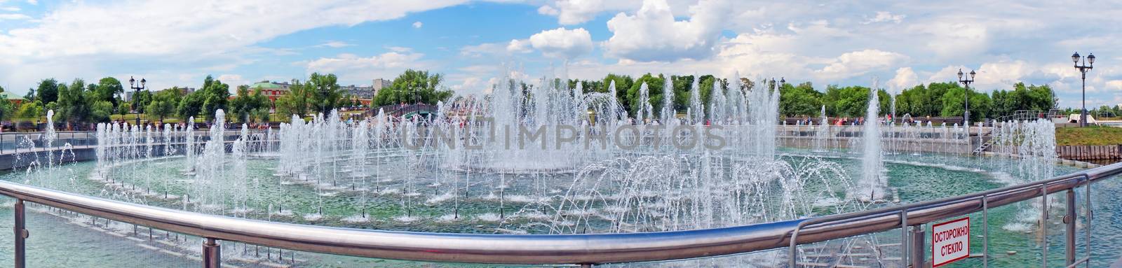 Panorama beautiful fountain against the blue sky with clouds