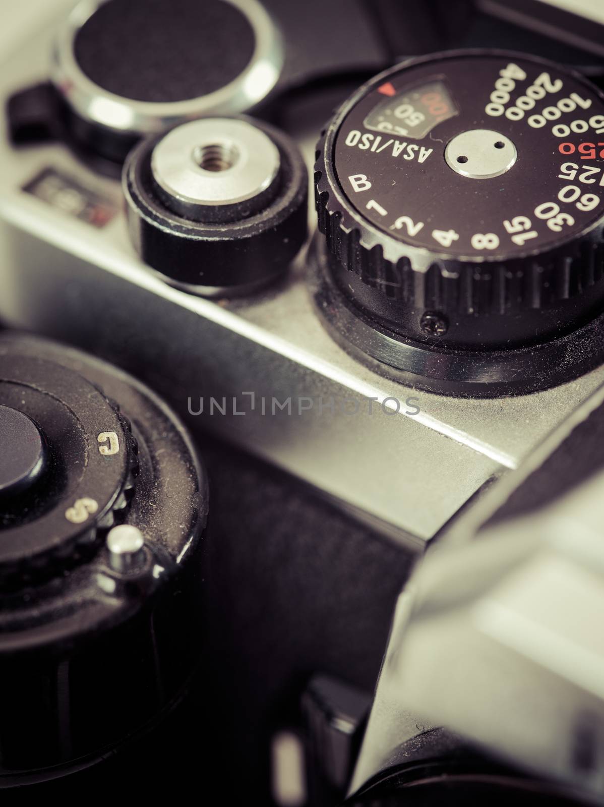 Macro photo of the shutter knob and shutter release of an old 35mm film camera. Filtered to look vintage.