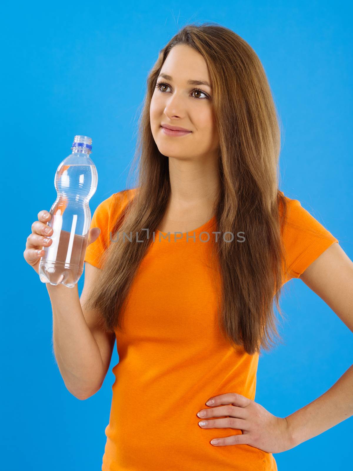 Happy young woman drinking water by sumners