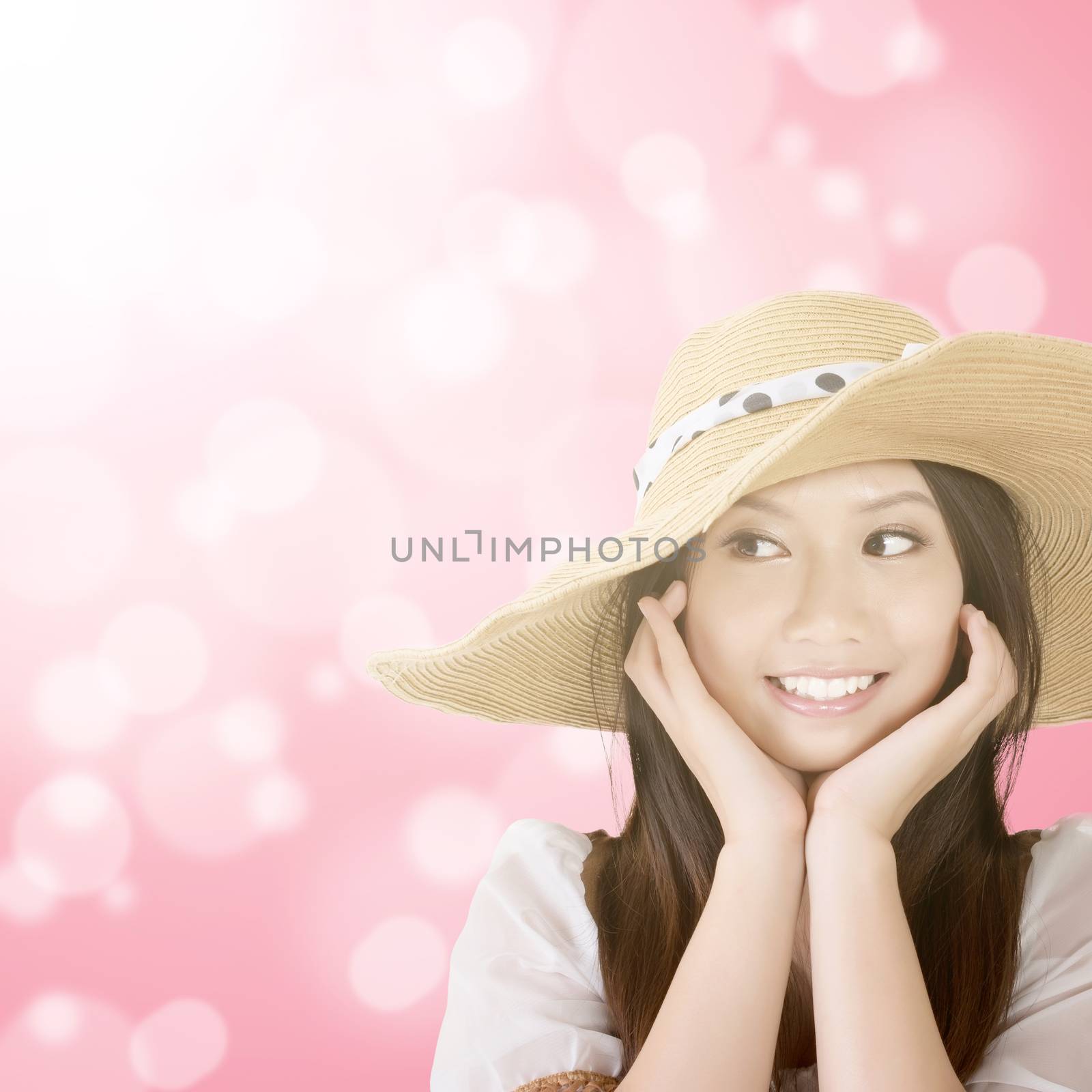 Young elegant asian woman with black hat posing against bokeh background.