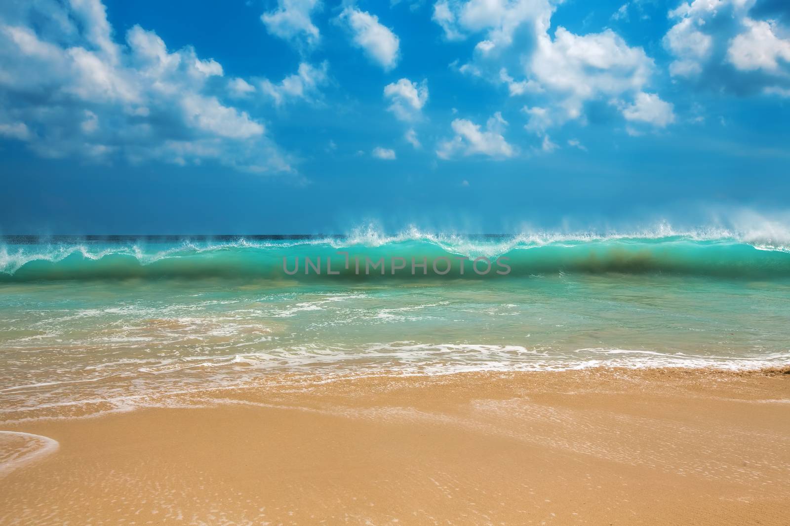 Surf waves and turqoise water along the coast of Bali