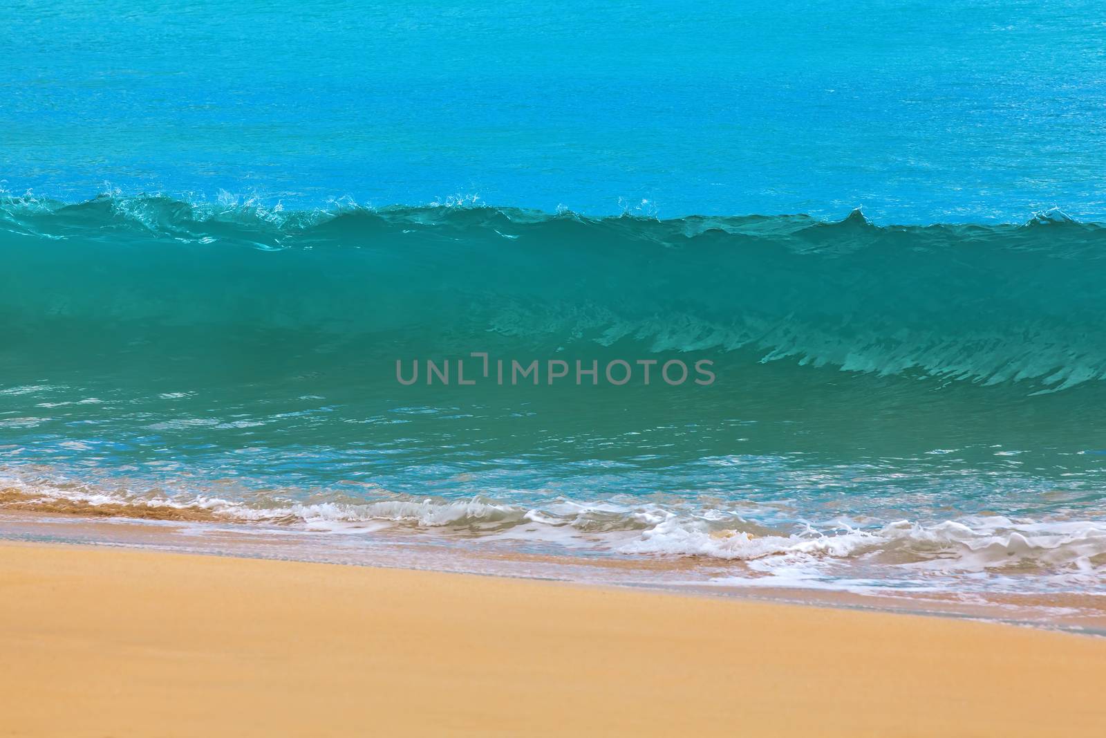 Surf waves and turqoise water along the coast of Bali