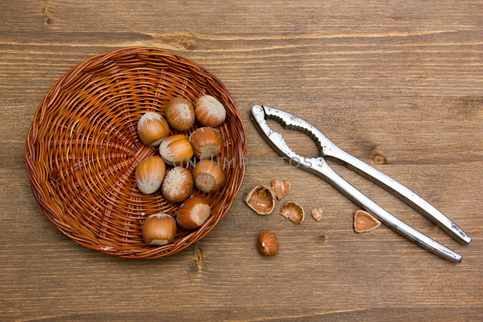 Hazelnuts and nutcracker on wooden table