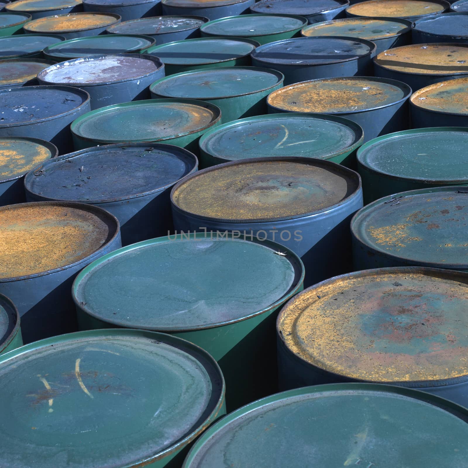 Rows of colorful and rusty barrels