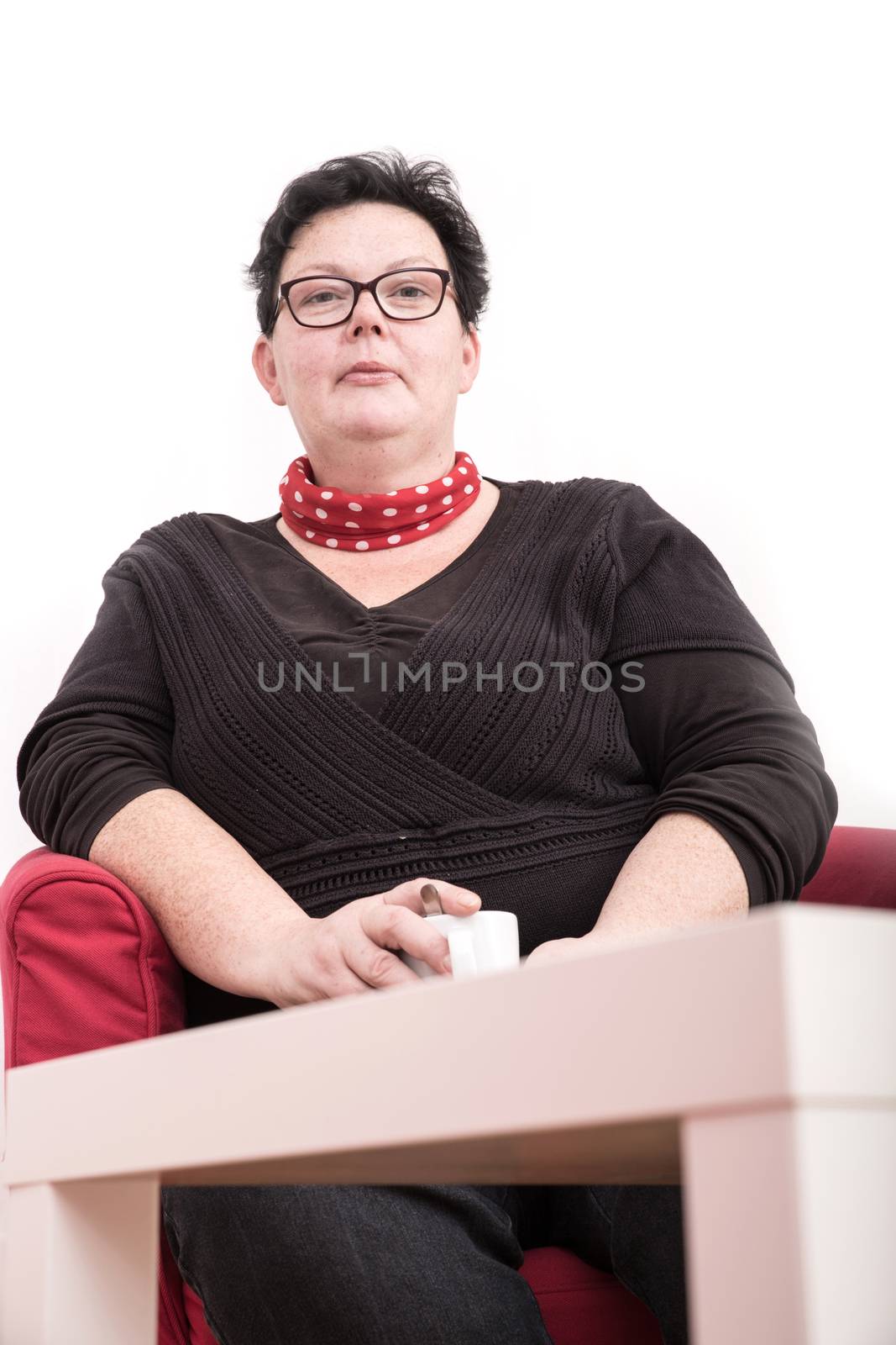 A relaxed woman sitting in the living room.