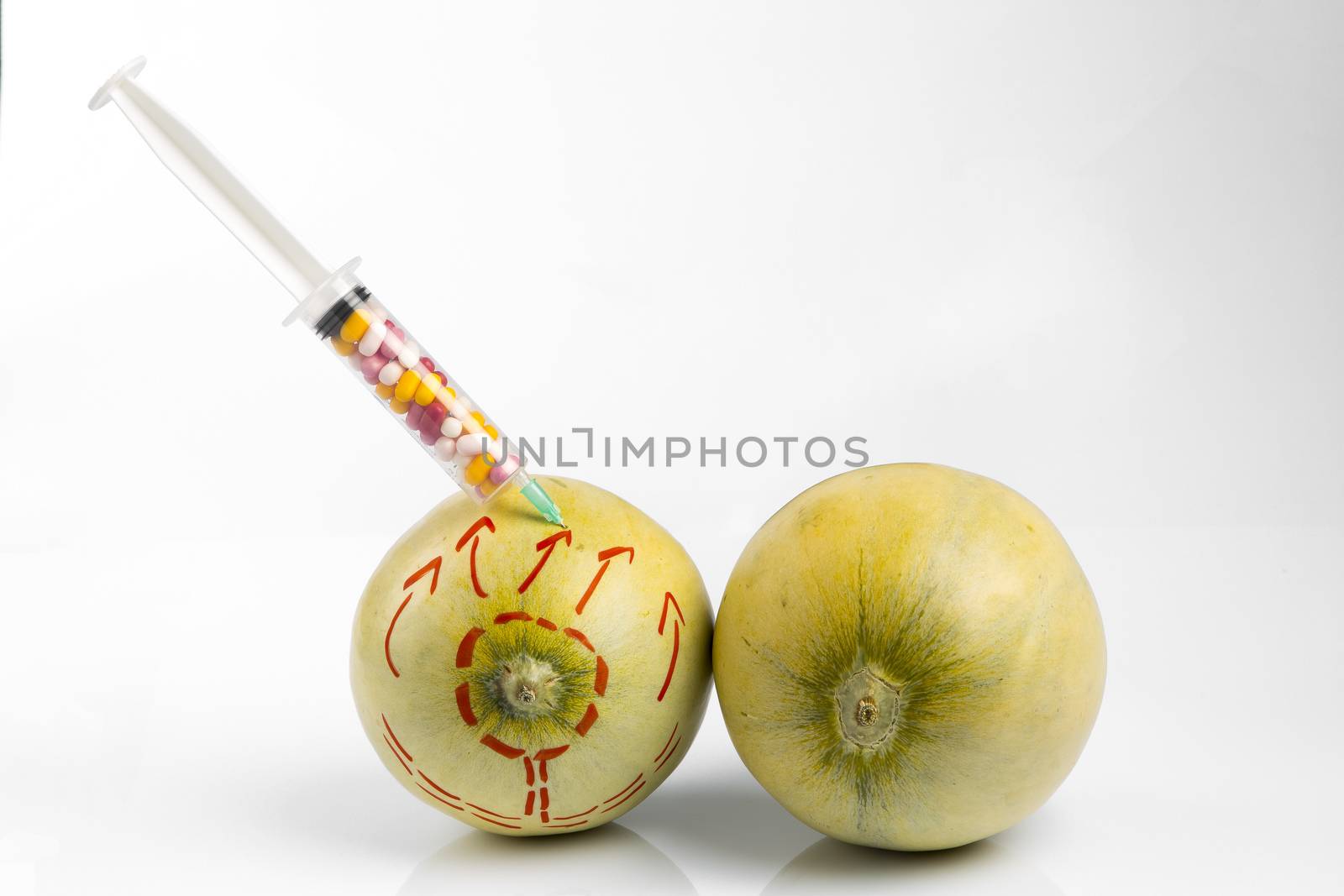 Melons and syringe with pills by paocasa