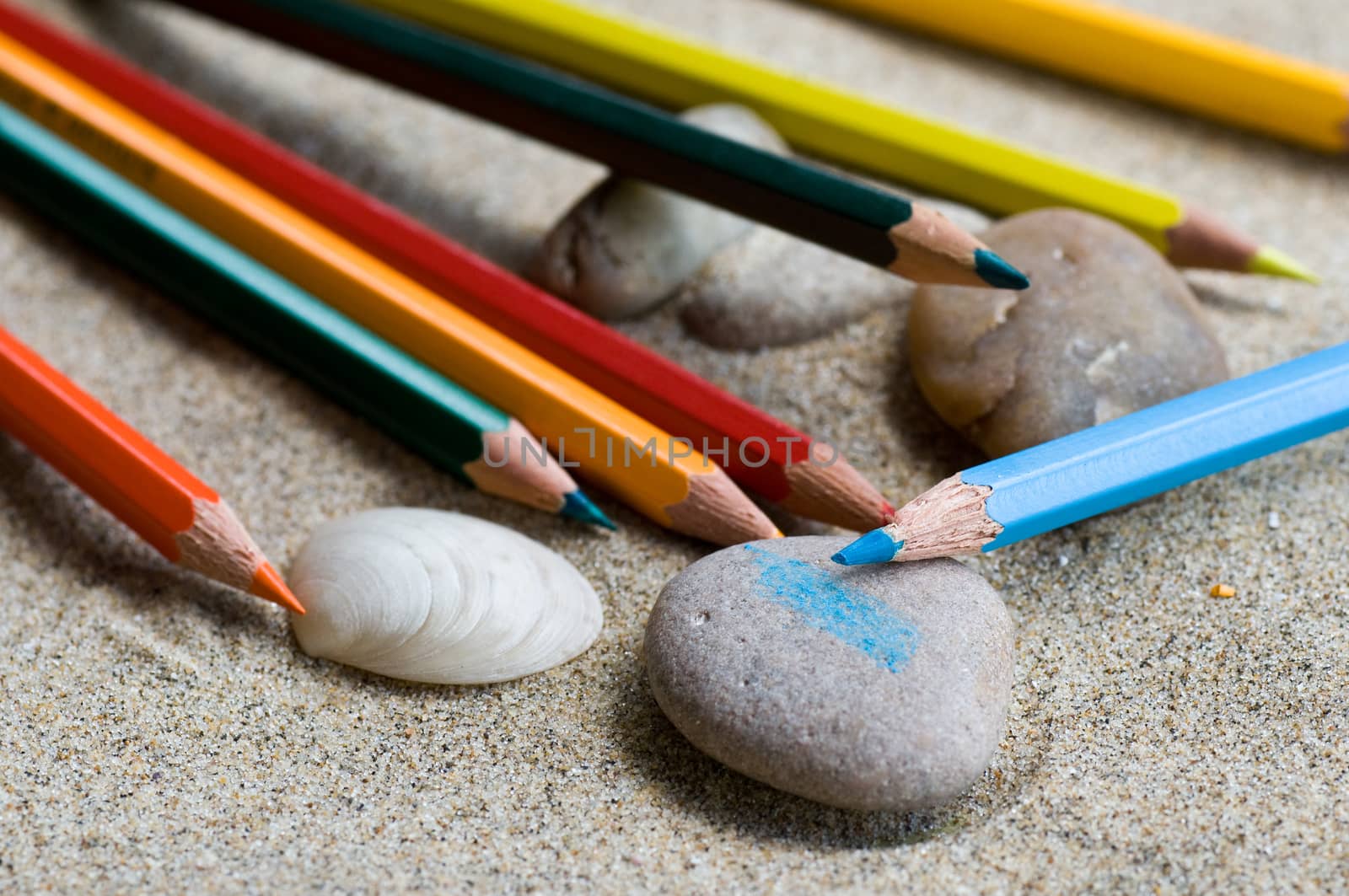 school supplies pencils colors on the beach